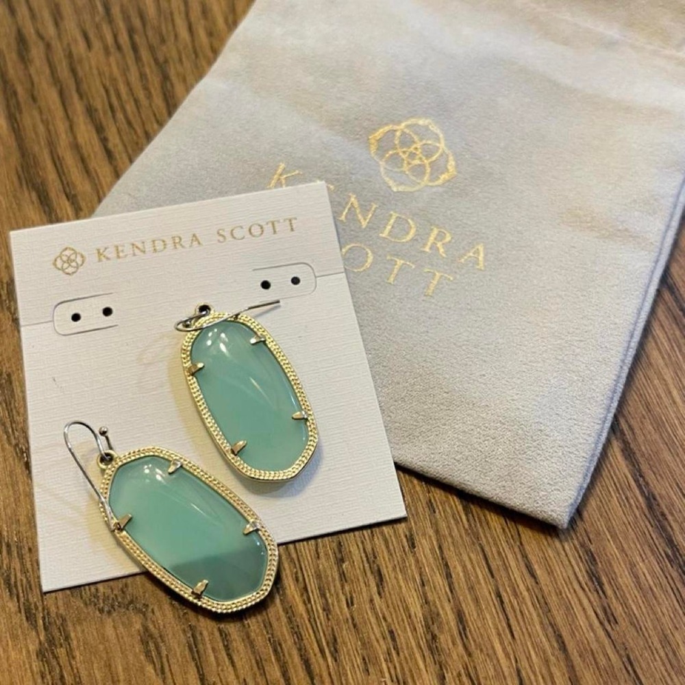 Kendra Scott earrings with light clear turquoise oval stones and gold detailing
